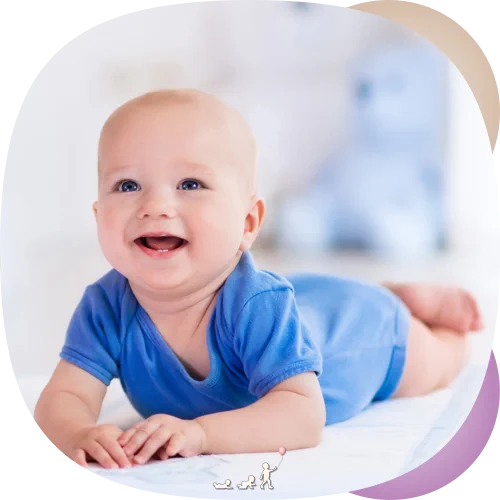 Happy baby on their tummy, lifting their head and looking up: motor development